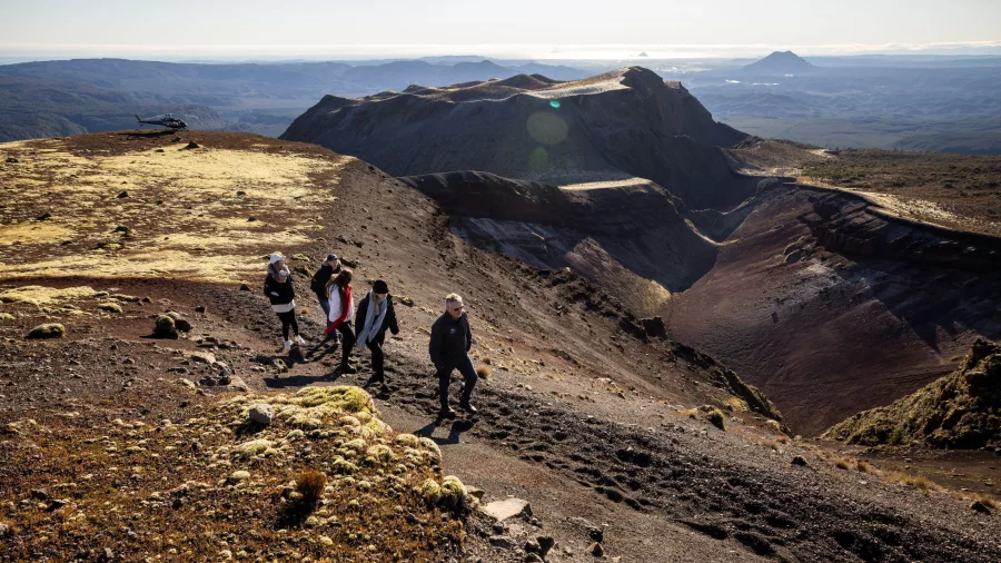 Group walking along Mt Tarawera’s crater ridge with sweeping volcanic views