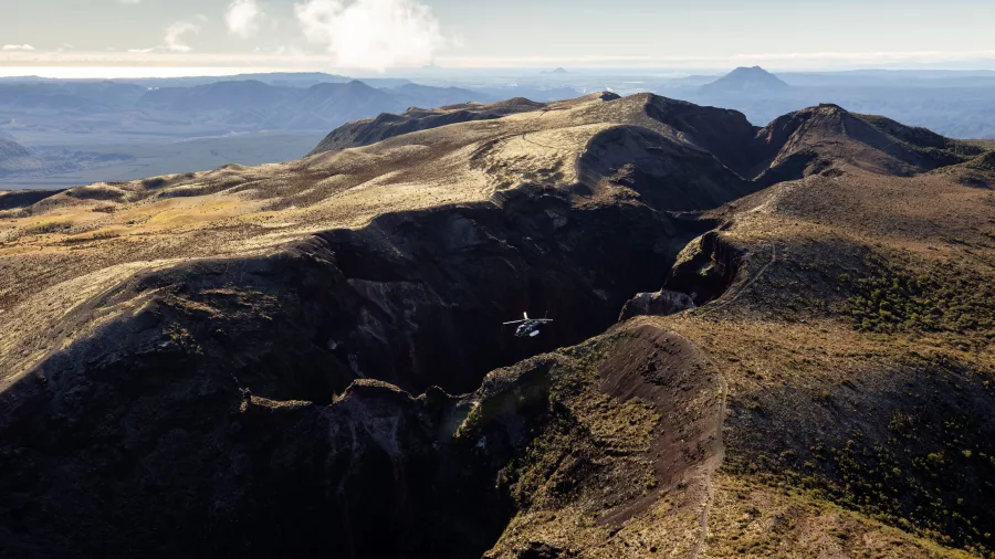 Helicopter flying above the dramatic crater of Mt Tarawera