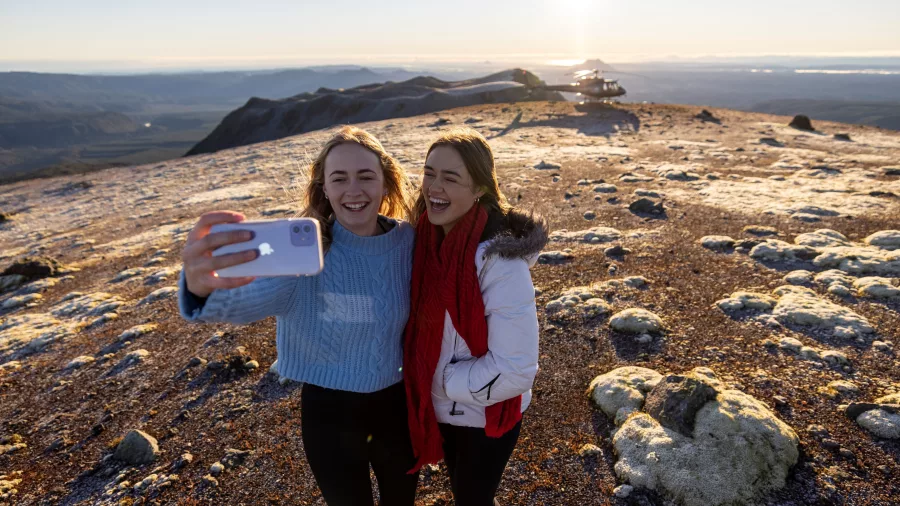 Two women taking a selfie on Mt Tarawera at sunrise