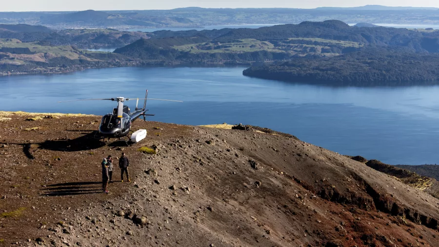 Helicopter parked on Mt Tarawera’s summit with Lake Tarawera in the background