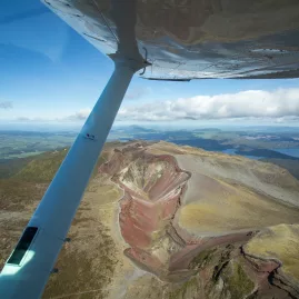 Passenger’s view from floatplane wing looking down over Mount Tarawera’s volcanic crater