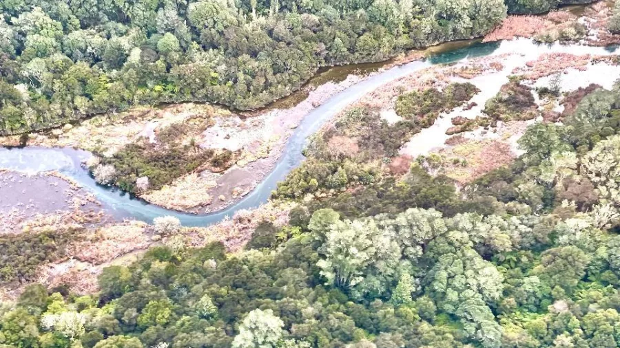 Aerial view of the Tarawera River winding through dense native forest near Mount Tarawera