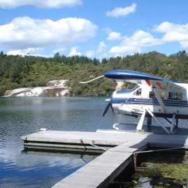 Floatplane at the jetty with steaming terraces at Orakei Korako, Taupō