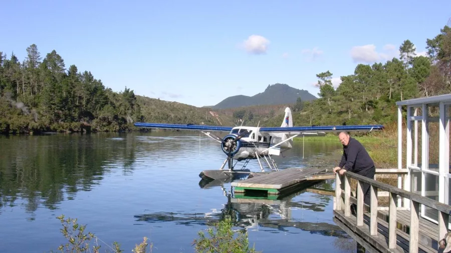 Seaplane parked at a quiet lodge jetty near Orakei Korako