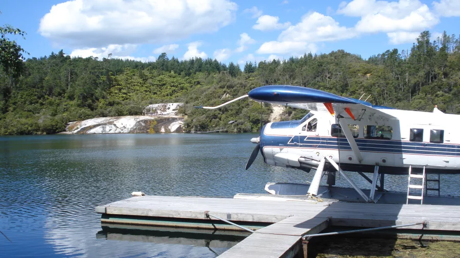 Floatplane at the jetty with steaming terraces at Orakei Korako, Taupō