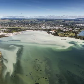 Aerial view of Sulphur Bay and Rotorua Lakefront with geothermal waters and cityscape in the background