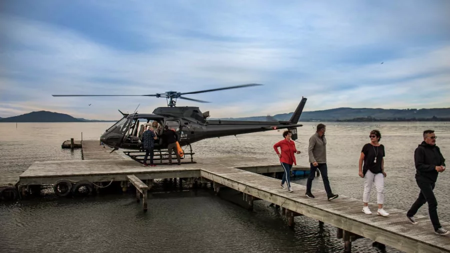 Passengers boarding Volcanic Air helicopter at Lake Rotorua jetty