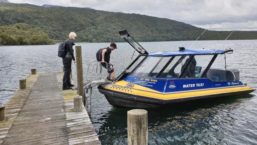 Guests boarding the water taxi on Lake Tarawera after the hike