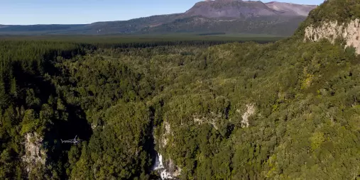 Helicopter flying over Tarawera Falls near Mount Tarawera