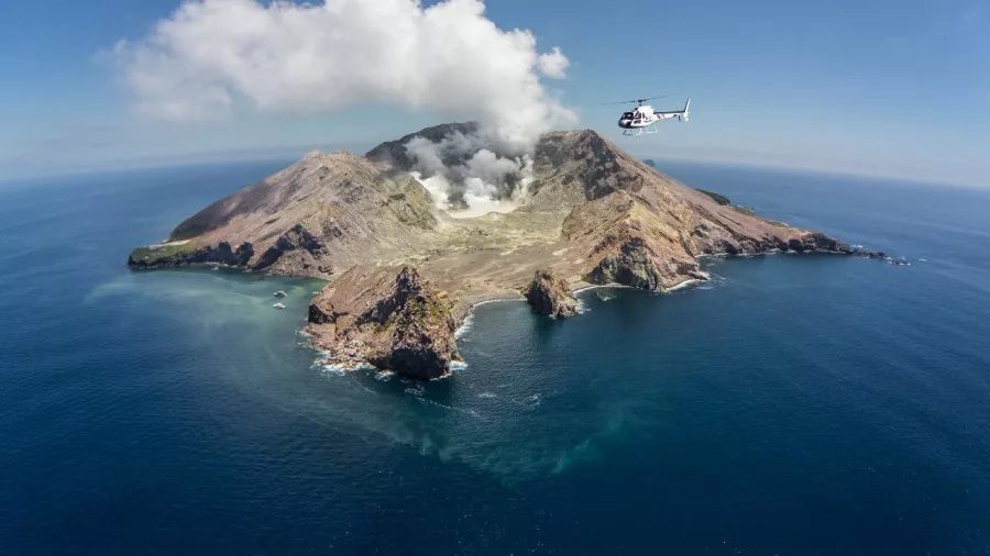 Helicopter flying over White Island (Whakaari), New Zealand’s most active marine volcano