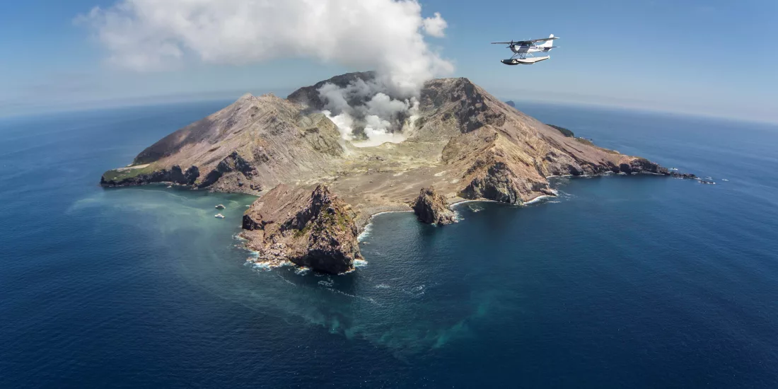 Floatplane flying over White Island, an active marine volcano off the Bay of Plenty coast