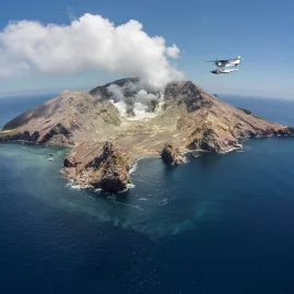 Floatplane flying over White Island, an active marine volcano off the Bay of Plenty coast