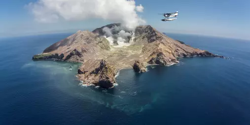 Floatplane flying over White Island, an active marine volcano off the Bay of Plenty coast