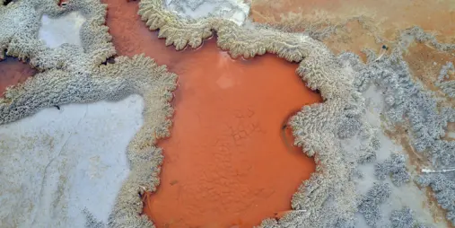 Vibrant mineral patterns and orange-coloured geothermal formations at Wai-o-Tapu, Rotorua