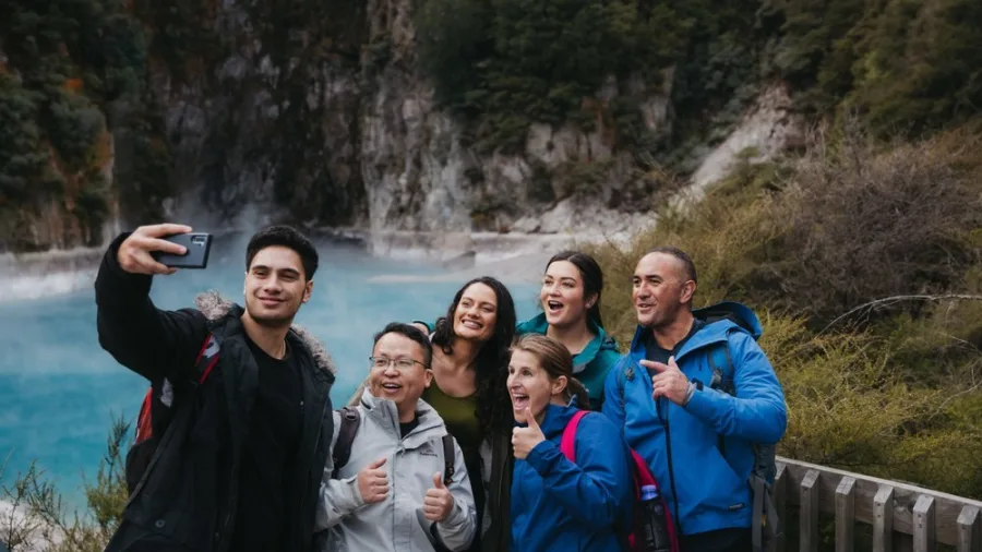 Group of friends taking a selfie in front of Inferno Crater at Waimangu Volcanic Valley