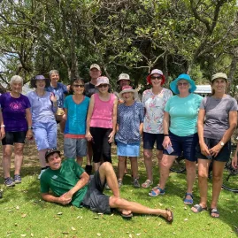 Smiling group of walkers posing together under shady trees during a Walking Legends Bucket List Walk