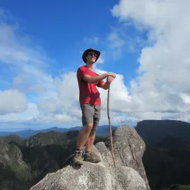 Male hiker standing proudly on the rocky summit of the Pinnacles in the Coromandel