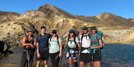 Hikers standing by Blue Lake in Tongariro National Park on a clear day