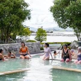 Women relaxing in a steaming thermal pool at Polynesian Spa, Rotorua, New Zealand