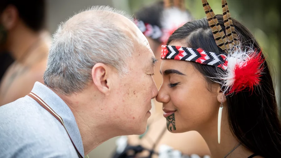 Visitor and Māori host greeting each other with a hongi at Te Puia in Rotorua