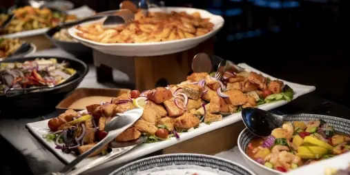 Hot dishes and meats from a traditional Māori hāngi buffet at Te Puia, Rotorua