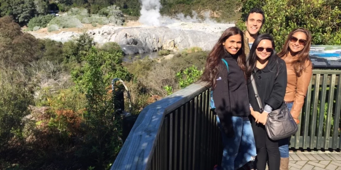 Tourists at Te Puia viewing platform overlooking Pōhutu Geyser in Rotorua