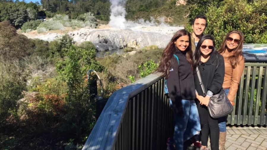 Tourists at Te Puia viewing platform overlooking Pōhutu Geyser in Rotorua