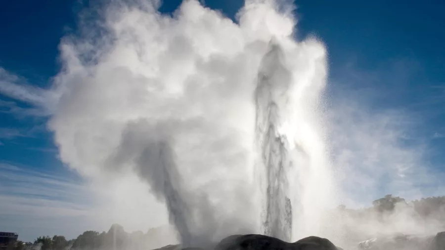 Pōhutu Geyser erupting with steam and water in Te Puia geothermal valley, Rotorua