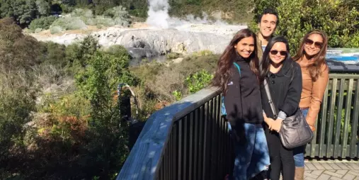 Tourists at Te Puia viewing platform overlooking Pōhutu Geyser in Rotorua