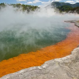 Wide view of Champagne Pool with thick steam and colourful mineral formations at Wai-O-Tapu near Rotorua