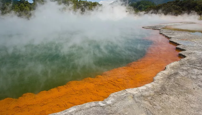Wide view of Champagne Pool with thick steam and colourful mineral formations at Wai-O-Tapu near Rotorua
