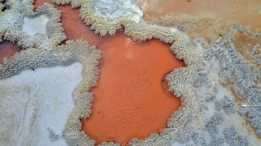 Vibrant mineral patterns and orange-coloured geothermal formations at Wai-o-Tapu, Rotorua