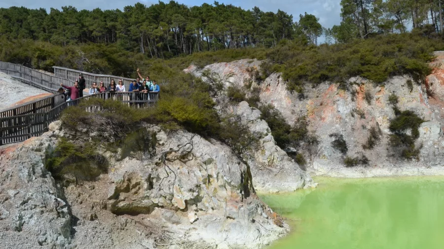 Devil’s Bath at Wai-O-Tapu, a vivid green sulphur pool surrounded by geothermal terrain in Rotorua, New Zealand