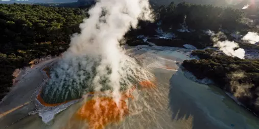 Aerial view of Champagne Pool with vibrant orange and green geothermal hues at Wai-O-Tapu
