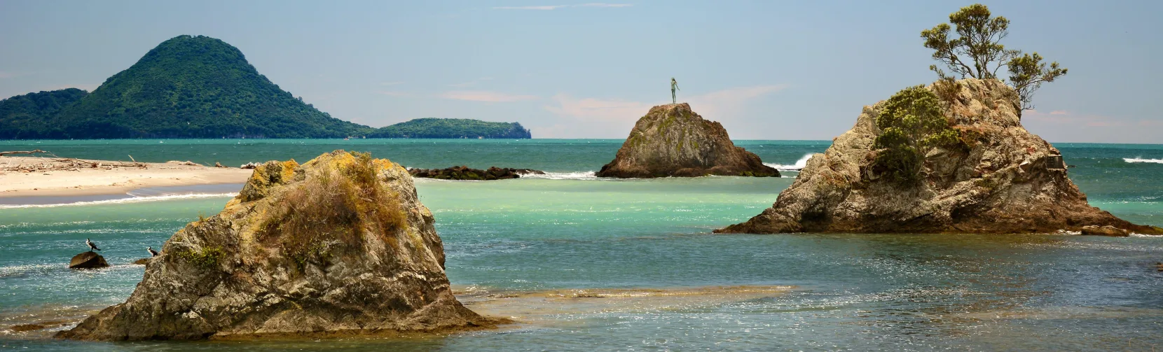 View of Whakatane Heads with Wairaka the Lady of the Rock statue in the Bay of Plenty, New Zealand