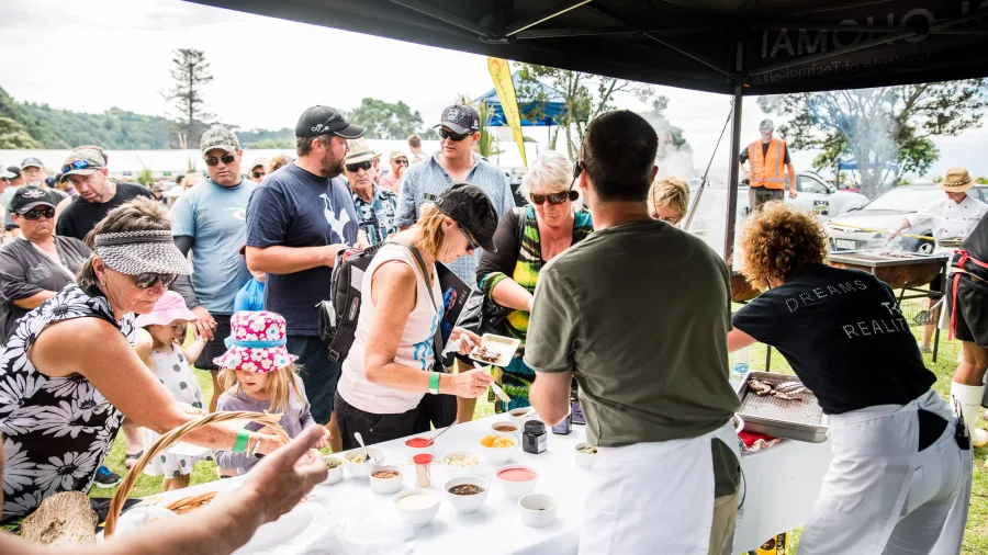 Visitors sampling unique dishes at the Local Wild Food Challenge in Ohope, Bay of Plenty, New Zealand