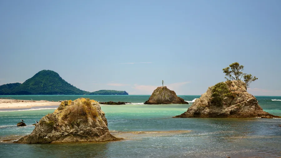 View of Whakatane Heads with Wairaka the Lady of the Rock statue in the Bay of Plenty, New Zealand