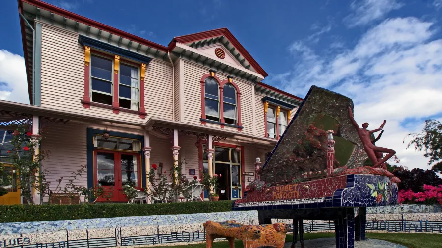 Mosaic piano sculpture in front of The Giants House villa in Akaroa, New Zealand