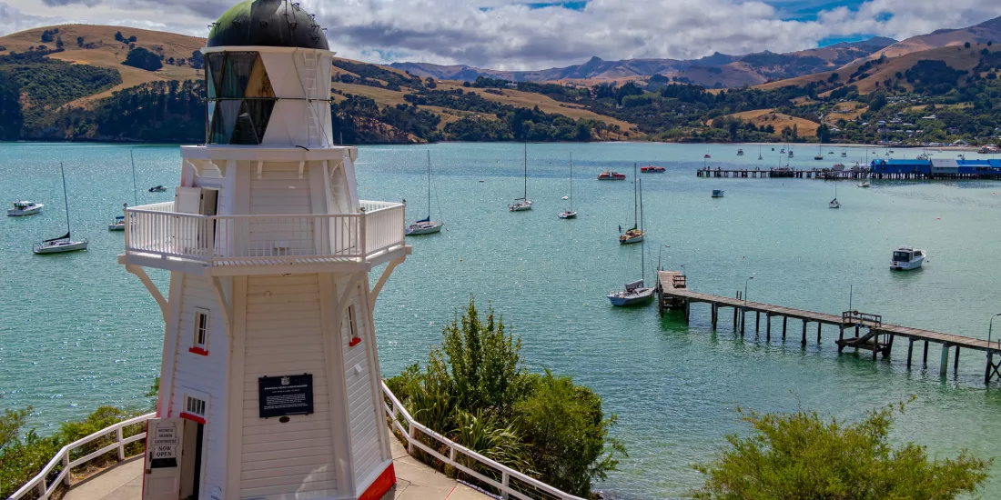 View of Akaroa Lighthouse overlooking the harbour and boats, Canterbury