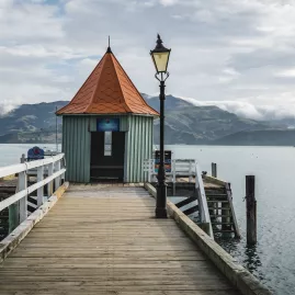 Daly’s Wharf extending into Akaroa Harbour, Canterbury, New Zealand
