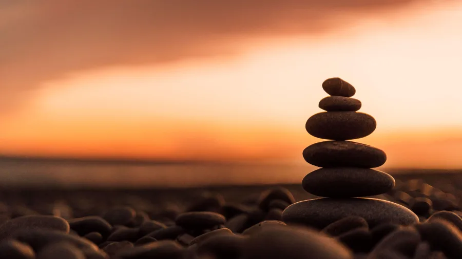 Stacked stones at sunset on a beach near Ashburton, New Zealand