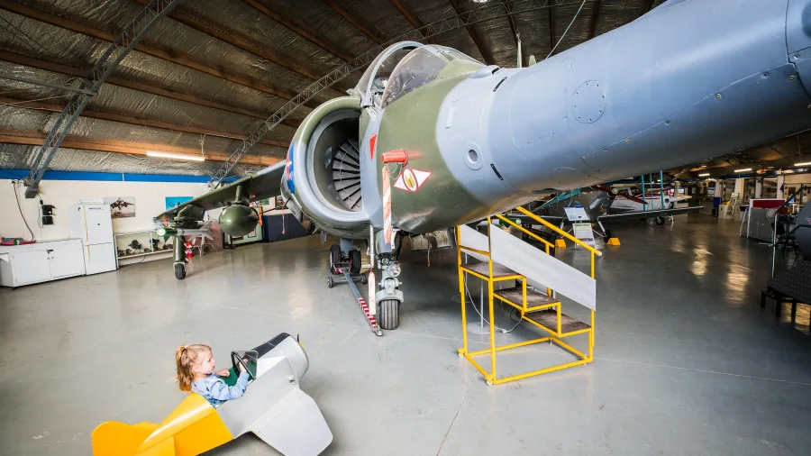 Harrier Jet display inside Ashburton Aviation Museum with child in cockpit model