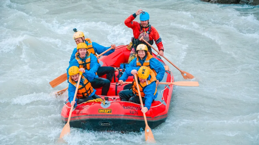 Rafting group smiling as they paddle down the Rangitata River