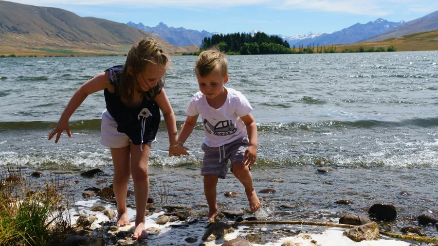Children exploring the shoreline of Lake Clearwater in Mid Canterbury