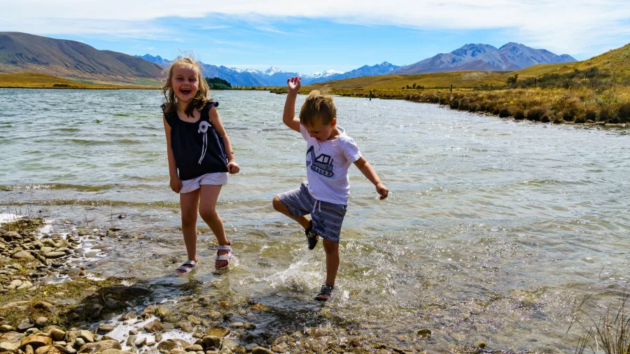Children splashing in the shallows of Lake Clearwater, Mid Canterbury
