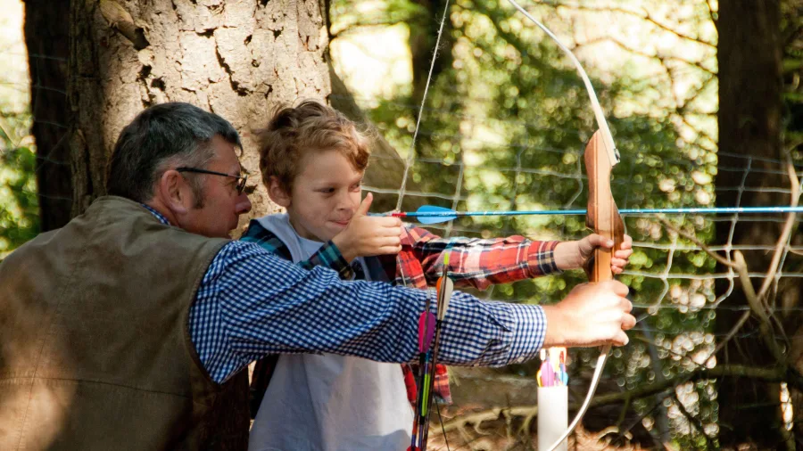 Young boy learning archery at NewZengland in Methven, Canterbury