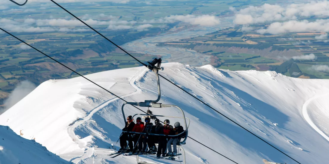 Skiers riding chairlift at Mt Hutt in Canterbury New Zealand