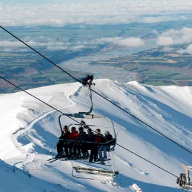 Skiers riding chairlift at Mt Hutt in Canterbury New Zealand