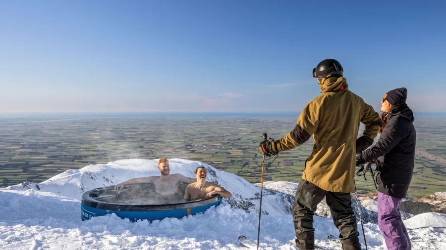 Skiers relaxing in mountain hot tub at Mt Hutt