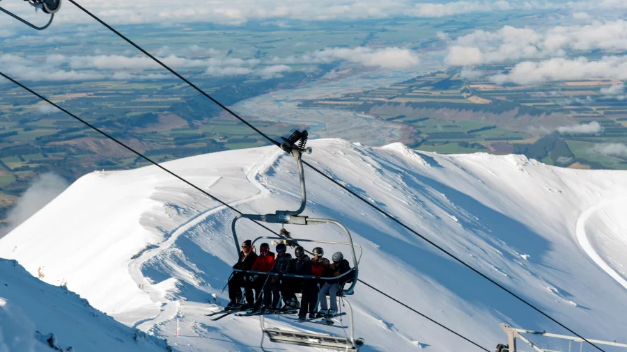 Skiers riding chairlift at Mt Hutt in Canterbury New Zealand